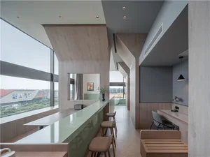 Modern high-ceiling living room featuring wood and concrete materials.