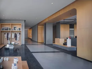 Modern hotel lobby featuring sleek concrete and wooden features.