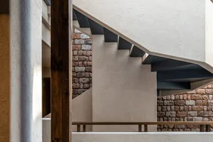 A modern staircase with concrete steps and walls in a contemporary interior design setting.