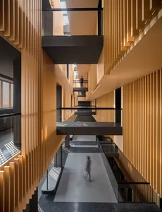 Modern architectural interior with wooden panels, concrete floors, and metallic accents