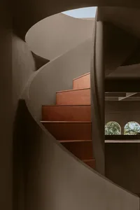 Spiral staircase with concrete steps and walls