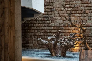 A living space with a stone wall, featuring a textured surface and rustic appeal.