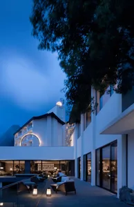 Modern hotel lobby featuring glass walls and a circular window