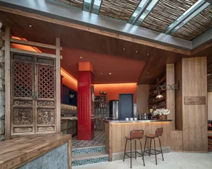 Modern industrial bar counter with wood-texture tiles and concrete flooring.