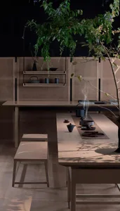 Modern, cozy tea ceremony space with wooden elements and greenery.