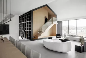 Modern living room with concrete floor, white furniture, and minimalist design