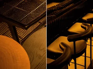 Barstools with curved armrests and padded leather seating in a modern restaurant interior