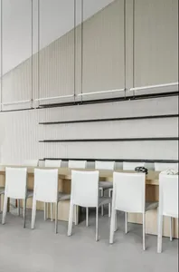 Modern restaurant interior with white leather chairs and wooden tables