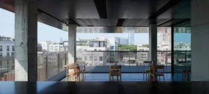 Modern rooftop restaurant with concrete and glass features