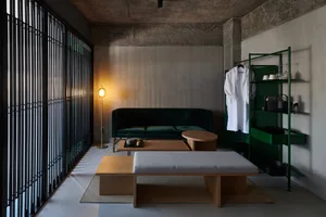 A modern living room with metal accents, wooden furniture, and textile upholstery