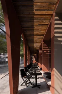 Outdoor seating area with wooden tables and chairs at a restaurant