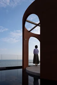A minimalist architectural space overlooking the sea.