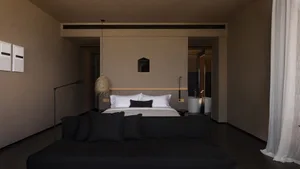 Modern minimalist bedroom featuring a concrete bed platform with leather headboard and wool pillows.