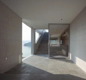 Interior design featuring modern, minimalist space with concrete walls and floor.
