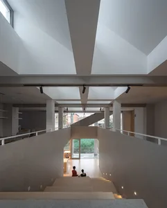 A modern living space with concrete walls and stairs, featuring a minimalist interior design.