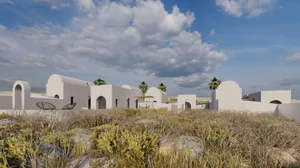 Modern residential houses with white walls and rounded arches, set against a backdrop of clouds and dry vegetation.