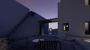 A modern residential exterior featuring concrete and rocks under a starry night sky.