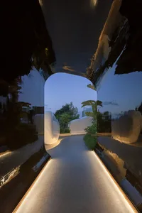 A minimalist pathway made of concrete with warm lighting.