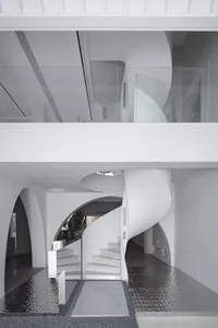 Modern, minimalist staircase made of concrete with a spiral design.