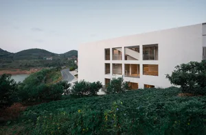 A modern building with large glass windows and a white exterior.