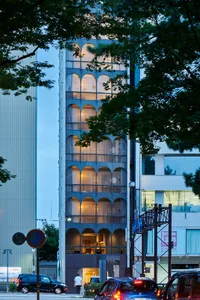 A modern building with glass exterior and arched windows.