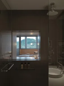 Modern residential interior with a large window showcasing a view of a serene landscape.
