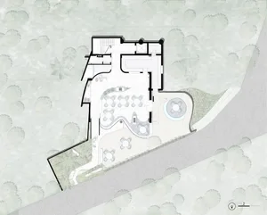 An overhead view of an indoor architectural space with tables and chairs.