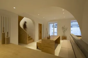 A minimalist interior design featuring wooden furniture and architectural elements.