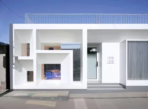 Minimalist architecture with white stone exterior and large windows