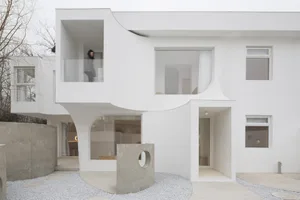 A modern white house featuring concrete and glass materials.