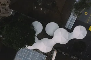 Aerial view of a public space with curved steel architectural elements.