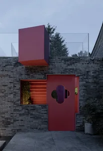 Modern exterior building facade with red painted brick and geometric architectural features