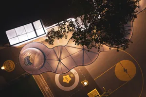 A modern outdoor playground with concrete structures and vibrant markings.