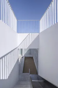 A modern interior space featuring concrete walls and flooring.