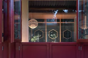 Modern restaurant interior with wooden panels and glass walls