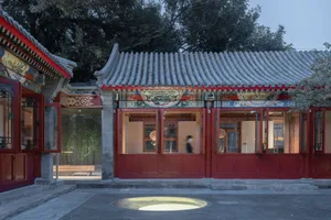 A traditional building with red doors and grey tiles.