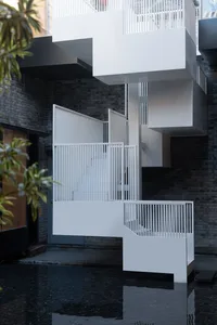 Modern exterior with metallic structure and white railing.