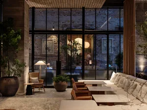 Industrially designed living room featuring brick walls, concrete floors, and modern furnishings.