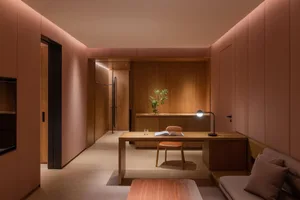 A minimalist office space featuring wooden and leather elements.