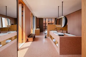 A modern hotel room featuring a terrazzo interior design with a minimalist and contemporary aesthetic.