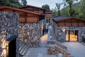 A modern residential building featuring stone exterior walls.