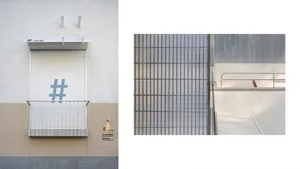 A minimalist building facade featuring black and white colors and a grid-like pattern.
