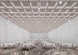 A spacious, minimalist banquet hall adorned with white cloth-covered tables and chairs.