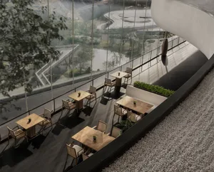 A modern cafe featuring wooden tables and chairs, with a scenic view outside.