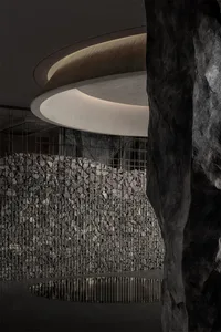 A modern corporate lobby featuring concrete walls and metal accents