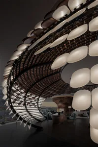 Modern lobby interior with metal and wooden elements and illuminated lighting fixtures