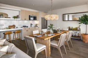 A modern residential kitchen with wooden furniture and a marble countertop.