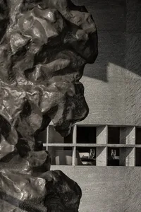 An interior photograph showcasing a modern restaurant with concrete shelving, emphasizing the minimalist design and industria