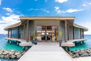 Modern architectural design of a water villa featuring wooden materials and a spacious exterior.