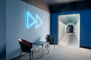 A minimalist corridor with metal railings and lighting features.